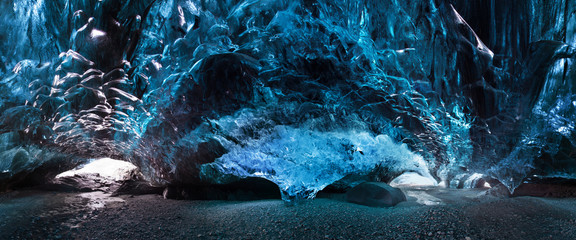 Blue crystal ice cave and an underground river beneath the glacier. Amazing nature of Skaftafell,...