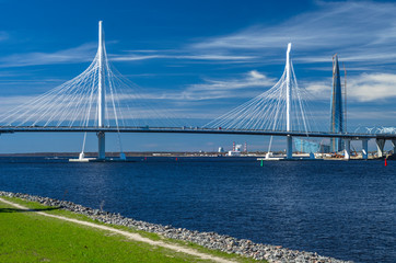A new white cable-stayed bridge across the Neva River. Large cable-stayed bridge against the blue sea. Modern bridge construction. The central part of the WHSD. Russia. St. Petersburg