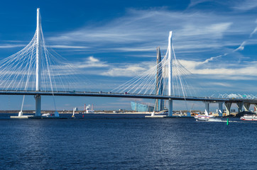 A new white cable-stayed bridge across the Neva River. Large cable-stayed bridge against the blue...