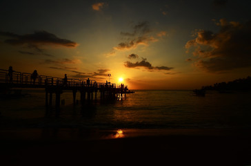Fototapeta na wymiar silhouette and sunset over the sea