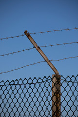 Barbed wired fence providing security to farmland in rural Hampshire