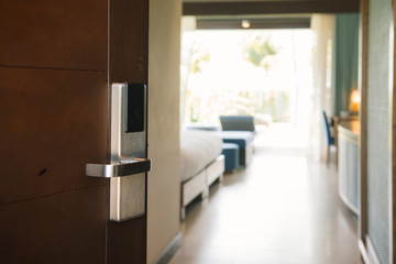 Hotel room , Condominium or apartment doorway with open door in front of blur bedroom background