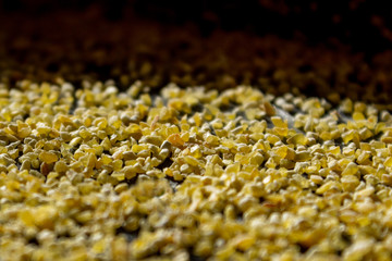 Corn grits groat background. Top view, closeup.