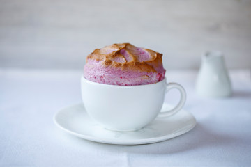 Raspberry souffle in a white cup