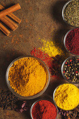 Turmeric ground. Place for text. Different types of Spices in a bowl on a stone background. The view from the top