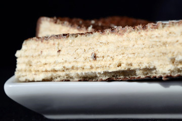 Slice of wafer cake on a plate closeup. Shallow depth of field