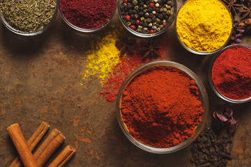 Red Ground Paprika. Place for text. Different types of Spices in a bowl on a stone background. The view from the top