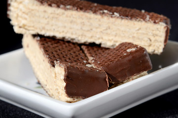 Pieces of waffle cake covered with icing. Shallow depth of field