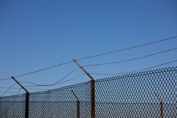 Barbed wired fence providing security to farmland in rural Hampshire