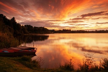 Colorful sunrise above pond.