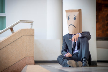 Men face paper bag gesture