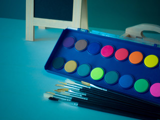 Watercolor at black background, Flat lay, top view, paintbrush image vintage,