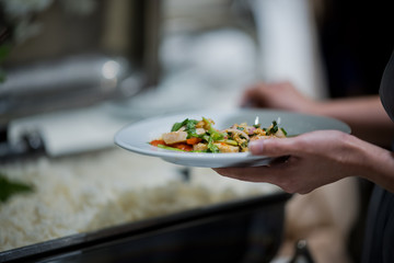scooping the food, buffet food at restaurant, catering 