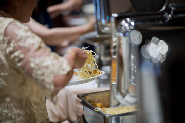 scooping the food, buffet food at restaurant, catering 