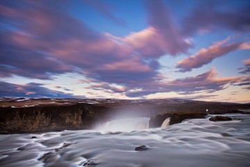 Unbelievable summer morning scene on the Godafoss Waterfall. Colorful sunrise on the on Skjalfandafljot river, Iceland, Europe. Beauty of nature concept background. Summer or autumn in Iceland.