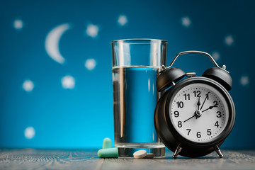 Earplugs, pills and alarm clock