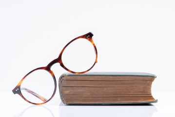 Glasses with book education and back to school concept picture