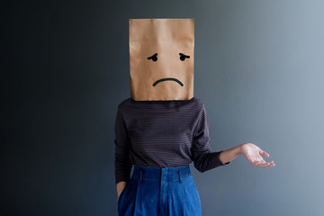 Customer Experience or Human Emotional Concept. Woman Covered her Face by Paper Bag and present...