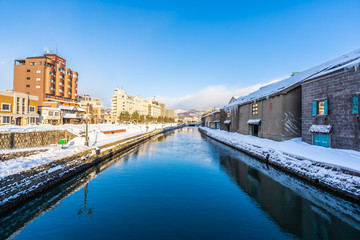 Fototapeta na wymiar Beautiful landscape and cityscape of Otaru canal river in winter and snow season