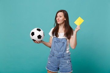Confused young woman football fan support team with soccer ball, yellow card propose player retire...