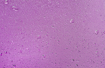 Water drips on purple.Abstract background.