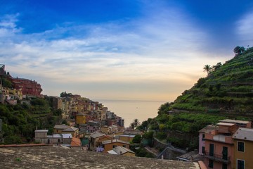 The small town of Manarola, which is located in the Cinque Terre national Park. Italian colorful town right by the sea. Beautiful evening sunset.