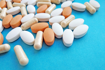 Fototapeta na wymiar Pharmaceutical pills, tablets and capsules on blue background. Medicine concept, pharmacy, treatment and drugs prescription theme