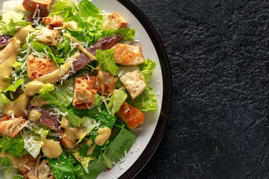 Caesar salad with chicken, anchous fish, croutons, parmesan cheese and greens. healthy food