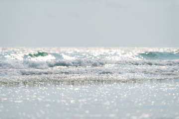 Bright sea surface with sun reflection, Selective focus bright water bubbles