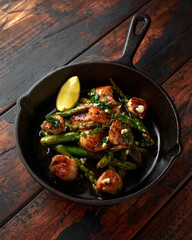 Scallops seared in garlic and parsley butter served in cast iron skillet