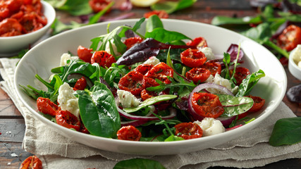 Sun dried tomatoes Salad with fresh vegetables mix and mozzarella cheese. healthy food. closeu up