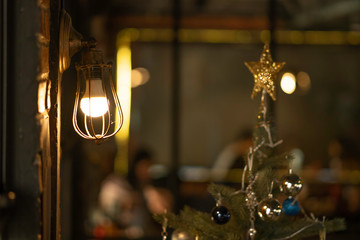Antique electronic lamp, hang at the red brick wall in the restaurant.soft focus.