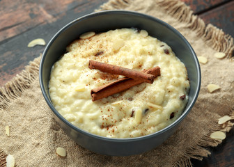 Classic rice pudding with cinnamon and almond nuts. healthy breakfast