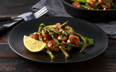 Scallops seared in garlic and parsley butter served on black plate