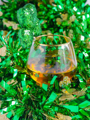 St Patricks Day Irish Whiskey Glass with Shamrock and TInsel Close up