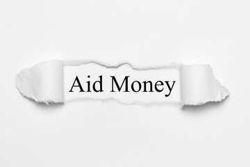 Aid Money on white torn paper