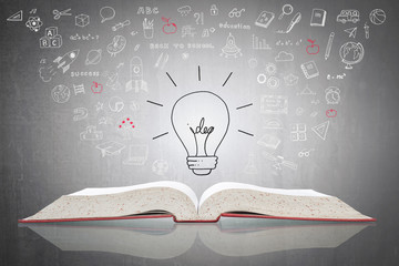 Innovative light bulb on book with doodle for World intellectual property day and education concept