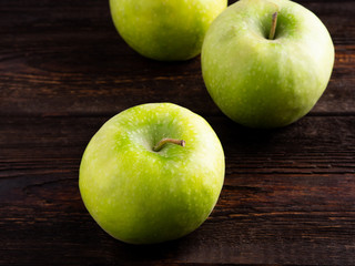 Apples on dark brown wooden background
