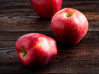 Apples on dark brown wooden background