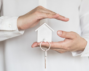 House key in home Insurance agent's hand protection