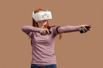 Emotional female with red long hair standing experiencing vertual reality headset for the first time. Generation of realistic images of alternative digital reality