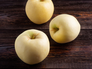 Apples on dark brown wooden background