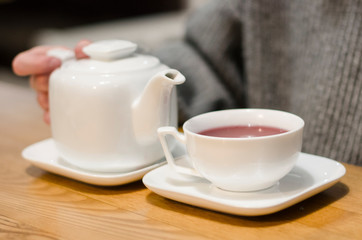 Pouring red tea into a cup