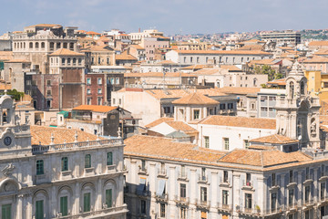 Fototapeta na wymiar Aerial skyline panoramic view of city of Catania in September, old town featuring brown, ochre and yellow roofs. Sicily, Italy. Vintage or travel background.