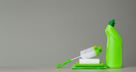 Green set of cleaning products and tools for spring cleaning.