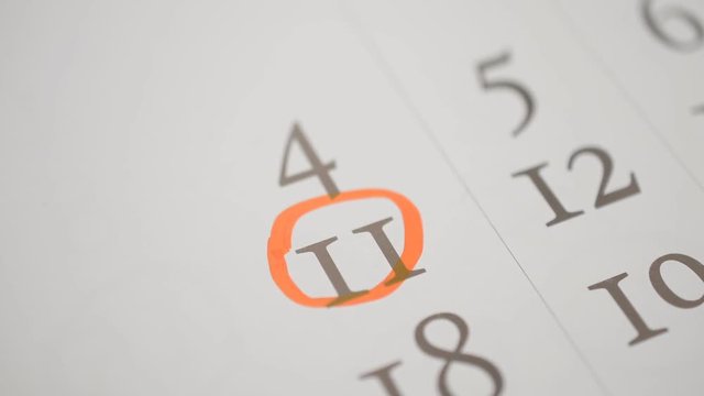 Signing a day on a calendar by red pem, independence day poland europe, eleventh number