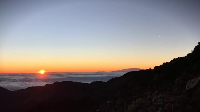 Tip of the sunrise at the top of Haleakala crater located on the Hawaiian island Maui