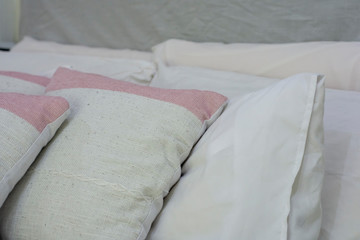 Closeup of new bed comforter with decorative pillows in staging model home