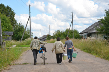  three people go through the village in a bicycle