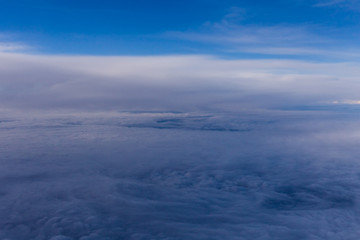 Fototapeta na wymiar White clouds and blue sky from an airplane